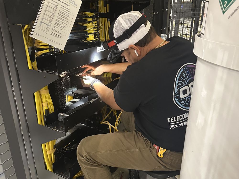 DDC technician terminating fiber modules in an optical distribution frame chassis