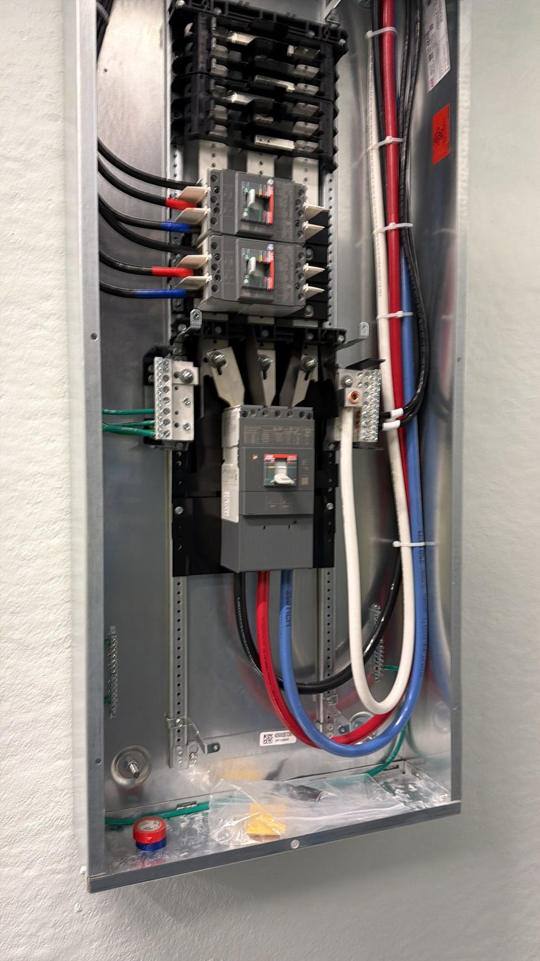 Electrical distribution panel with breakers and interconnected feeders