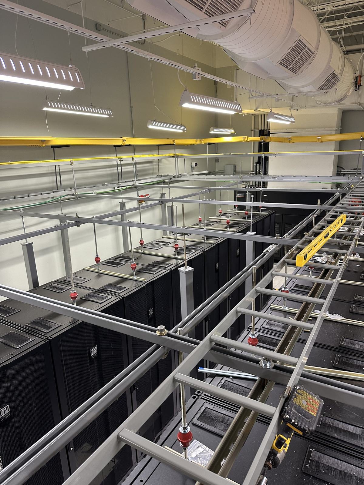 Overhead ladder rack installed across a row of cabinets