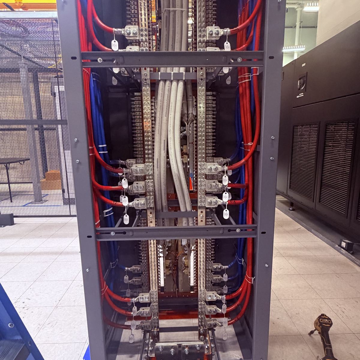 Vertical DC busbar and breaker frame with red and blue feeders