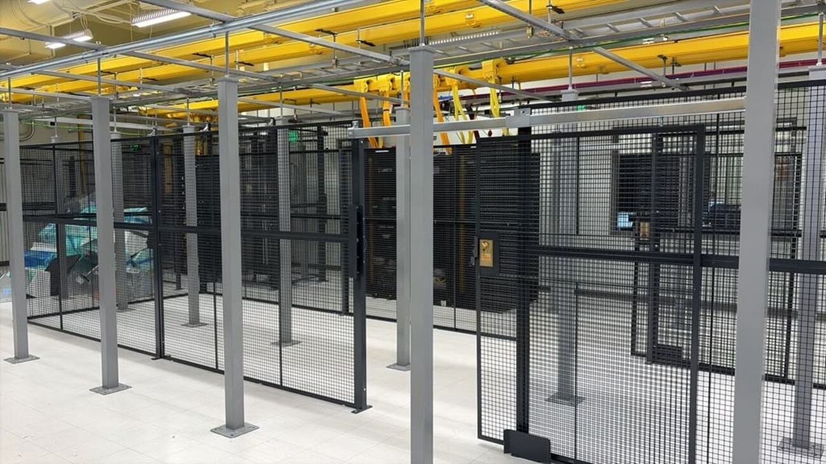 Caged suite with mesh partitions and cabinet rows