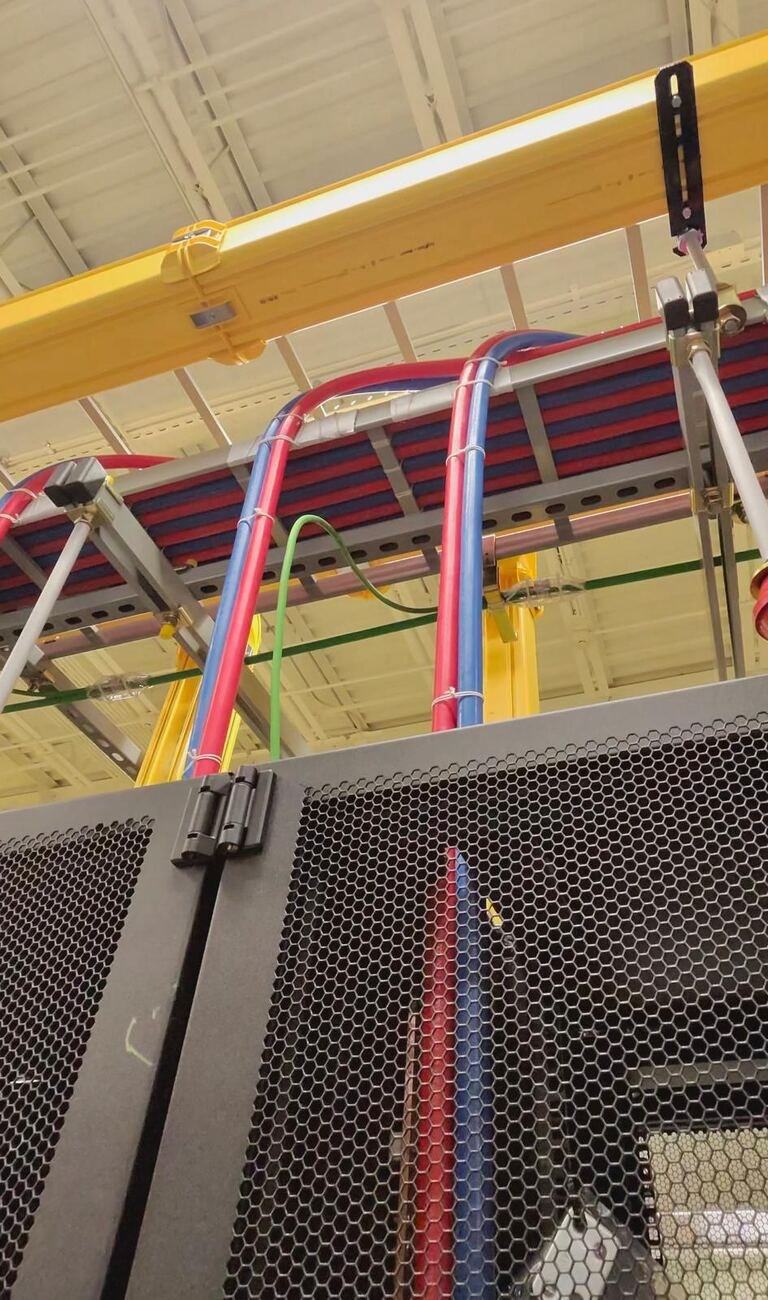 Overhead feeder routing into a cabinet